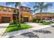 Gorgeous townhome featuring a lush green lawn, mature landscaping and a private, attached garage at 30130 Mossbank Dr, Wesley Chapel, FL 33543