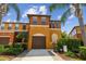 Beautiful multi-story townhome with a private garage, a well-manicured lawn and mature landscaping at 30130 Mossbank Dr, Wesley Chapel, FL 33543