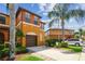 Lovely multi-story townhome with private garage, beautiful landscaping and mature palm trees at 30130 Mossbank Dr, Wesley Chapel, FL 33543