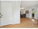 Bright foyer with hardwood flooring leading to dining area, showcasing an open and inviting layout at 30130 Mossbank Dr, Wesley Chapel, FL 33543