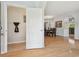 Inviting foyer with hardwood floors flowing into dining area with decorative chandelier and archway to kitchen at 30130 Mossbank Dr, Wesley Chapel, FL 33543