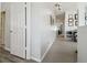Hallway leading to multiple rooms with neutral carpet and paint at 30130 Mossbank Dr, Wesley Chapel, FL 33543