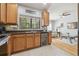Open concept kitchen with stainless steel appliances, wooden cabinets, tile backsplash, and a wine cooler at 30130 Mossbank Dr, Wesley Chapel, FL 33543