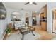 Open concept living room with hardwood floors leading into the kitchen with stainless steel appliances at 30130 Mossbank Dr, Wesley Chapel, FL 33543