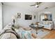 Living room with a ceiling fan, hardwood floors and a view into another room through an archway at 30130 Mossbank Dr, Wesley Chapel, FL 33543