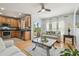 Open concept living room with hardwood floors, a view of the backyard, and open to the kitchen at 30130 Mossbank Dr, Wesley Chapel, FL 33543