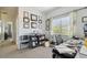 A cozy home office features natural light, neutral carpeting, and professional décor at 30130 Mossbank Dr, Wesley Chapel, FL 33543
