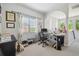A home office offers natural light, a comfortable workspace, and organized storage at 30130 Mossbank Dr, Wesley Chapel, FL 33543