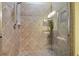 Shower with glass door and beige tile surround at 30130 Mossbank Dr, Wesley Chapel, FL 33543