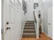 Carpeted stairs with white risers and wood floors leading to the upper level of the home at 30130 Mossbank Dr, Wesley Chapel, FL 33543