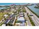 Aerial view of property with a pool and mature landscaping near the beach and city at 3214 E Maritana Dr, St Pete Beach, FL 33706
