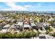 Aerial view of property with mature trees, landscaping and ocean in the distance at 3214 E Maritana Dr, St Pete Beach, FL 33706