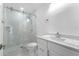 Modern bathroom features glass shower doors, sleek fixtures, and bright white walls at 3214 E Maritana Dr, St Pete Beach, FL 33706
