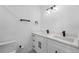 A bathroom features a double sink vanity with modern fixtures, a clean and minimalist design at 3214 E Maritana Dr, St Pete Beach, FL 33706