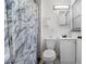 Bathroom with shower featuring gray-marbled shower curtain and marble-tiled shower at 3214 E Maritana Dr, St Pete Beach, FL 33706