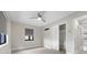 Bright bedroom featuring a modern fan, gray shades, and closet with a door leading into the room at 3214 E Maritana Dr, St Pete Beach, FL 33706