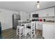 Kitchen features stainless steel appliances, dark countertops and white cabinets at 3214 E Maritana Dr, St Pete Beach, FL 33706