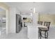 Bright kitchen with stainless appliances, white cabinetry, an island with barstool seating at 3214 E Maritana Dr, St Pete Beach, FL 33706