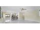 Bright living room with glossy tile floors, fan and bar stool seating at kitchen counter at 3214 E Maritana Dr, St Pete Beach, FL 33706