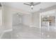 Bright, open living room featuring sleek tile floors and a view into the modern kitchen at 3214 E Maritana Dr, St Pete Beach, FL 33706