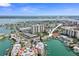 Sweeping aerial capturing waterfront condos, boat docks, and the wide ocean at 400 Larboard Way # 103, Clearwater, FL 33767
