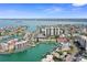 Sweeping aerial view of a coastal community with waterways and lush landscape; clear blue skies above at 400 Larboard Way # 103, Clearwater, FL 33767