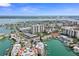 Expansive aerial view of a coastal community with waterways, buildings, and lush green landscaping at 400 Larboard Way # 103, Clearwater, FL 33767