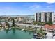 Expansive aerial view showcasing waterfront condos, boat docks, and surrounding ocean at 400 Larboard Way # 103, Clearwater, FL 33767