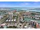 Aerial view of community with boat docks, waterfront condos, and covered parking at 400 Larboard Way # 103, Clearwater, FL 33767