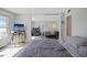 Bedroom featuring mirrored closet doors reflecting desk area and a television set with beach scene at 400 Larboard Way # 103, Clearwater, FL 33767