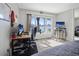 Bright bedroom featuring a desk area, a large window with water views, and mirrored closet doors at 400 Larboard Way # 103, Clearwater, FL 33767
