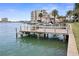 View of a private wooden dock over the water with surrounding waterfront properties at 400 Larboard Way # 103, Clearwater, FL 33767