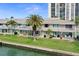Waterfront condo featuring multiple balconies, patios, and lush green space at 400 Larboard Way # 103, Clearwater, FL 33767