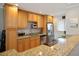 Bright kitchen boasts stainless steel appliances, tile backsplash, and light wood cabinets for ample storage at 400 Larboard Way # 103, Clearwater, FL 33767