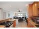 Open concept kitchen features stainless steel appliances, granite countertops, and a view of the living area and waterfront at 400 Larboard Way # 103, Clearwater, FL 33767