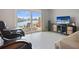 The living room boasts waterfront views, sliding glass doors to the patio, tile floors, and a cozy seating area at 400 Larboard Way # 103, Clearwater, FL 33767
