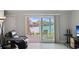 Open living room with waterfront view, sliding glass doors to patio, comfortable seating, and tile floors at 400 Larboard Way # 103, Clearwater, FL 33767