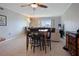 Open living area with dining set, tile flooring, and a large window showcasing the waterfront view at 400 Larboard Way # 103, Clearwater, FL 33767