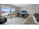 Living area features a sliding door to a patio, waterfront views, tile floors, and comfortable seating at 400 Larboard Way # 103, Clearwater, FL 33767