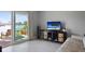 Bright living room features sliding glass doors with water views, tile floors, and comfortable furniture at 400 Larboard Way # 103, Clearwater, FL 33767