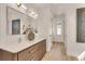 Elegant bathroom featuring double sink vanity with wood cabinetry and large mirror with contemporary lighting at 413 W Park Ave # 1, Tampa, FL 33602
