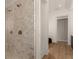 Contemporary bathroom with marble-tiled shower, glass door, and modern fixtures, next to hallway at 413 W Park Ave # 1, Tampa, FL 33602