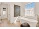 Bright bathroom featuring modern tub, sleek fixtures, and natural light streaming through the windows at 413 W Park Ave # 1, Tampa, FL 33602