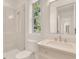 Bright bathroom featuring a glass enclosed shower, a large mirror, and ample counter space with a single sink at 413 W Park Ave # 1, Tampa, FL 33602