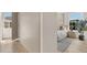 Hallway featuring modern, minimalist white cabinetry extending the length of the wall with bedroom view at 413 W Park Ave # 1, Tampa, FL 33602