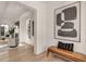 Bright hallway with hardwood floors, a stylish bench, and modern artwork at 413 W Park Ave # 1, Tampa, FL 33602