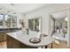 Bright kitchen featuring an island with a white countertop, neutral cabinetry, and stainless steel appliances at 413 W Park Ave # 1, Tampa, FL 33602