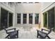 Outdoor patio with modern seating, travertine flooring, and a serene atmosphere perfect for relaxation and entertaining at 413 W Park Ave # 1, Tampa, FL 33602