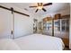 Comfortable bedroom with a sliding barn door, ceiling fan, and built-in storage cabinets at 4426 3Rd N Ave, St Petersburg, FL 33713