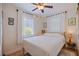 Bright bedroom featuring a ceiling fan, hardwood floors, and a window with natural light at 4426 3Rd N Ave, St Petersburg, FL 33713